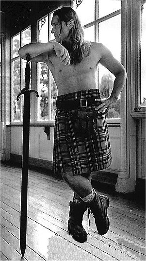 A handsome man in a fine kilt with a really big... sword!